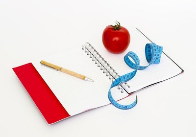 Notebook, tomato, ribbon and pen