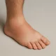 Swollen male ankle and foot with visible redness