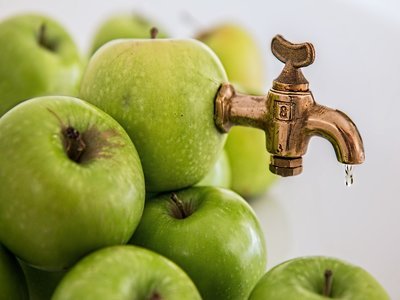 Green apples and kitchen faucet