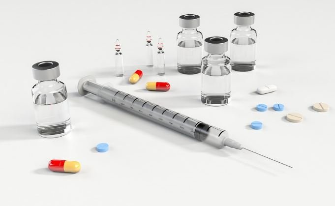 syringe, ampoule and pills