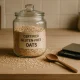 Certified gluten-free oats in a glass jar with raw oats and wooden spoon on kitchen counter
