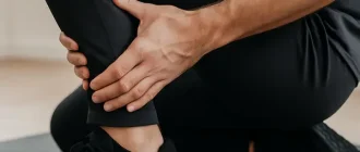 calf muscle cramp relief through massage in sports clothing
