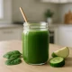 Glass jar of green detox smoothie on a kitchen counter, symbolizing dietary causes of green stool such as leafy greens and health drinks often linked to changes in stool color.