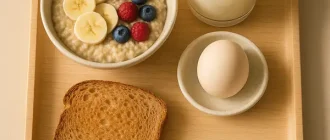Balanced pregnancy breakfast with oatmeal, boiled egg, toast, and milk on tray — high-calorie nutritious meal idea.