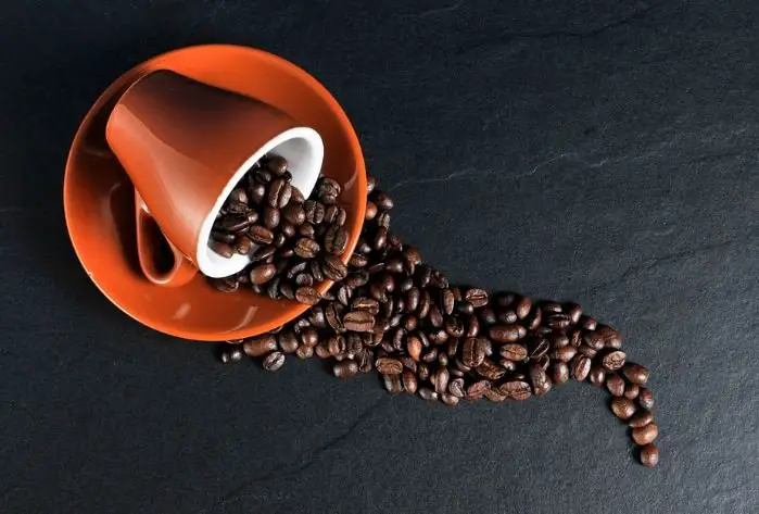 coffee beans and cup with saucer