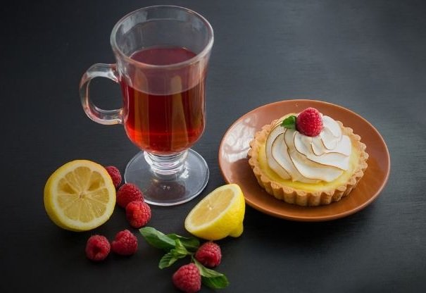 Cup of tea, cake, lemon and raspberry