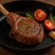 Pan-seared lamb chop with tomatoes and rosemary, illustrating safe red-meat options for pregnant women.