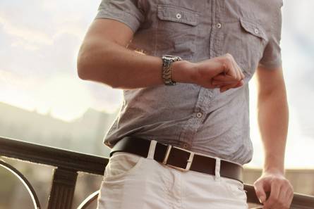 A man is looking at his watch