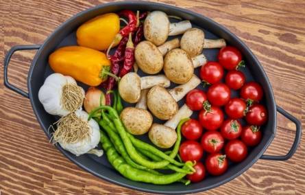 Fresh mushrooms with vegetables in a frying pan