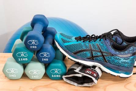 Colored dumbbells, ball and sneakers