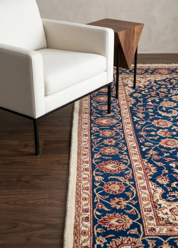 Vertical shot showing traditional Persian rug patterns contrasting against the sleek black metal legs and light wood texture of a modern accent chair.